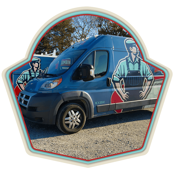 Blue van with cartoon plumber graphics parked on gravel, trees in background, badge-shaped frame around the image.